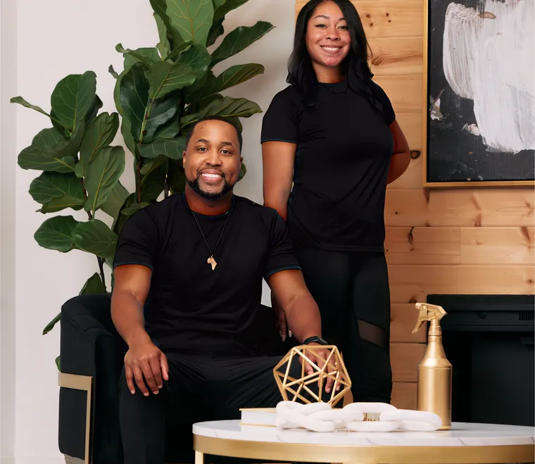 Jerod and Fancy, co-owners of The Fancy Cleaning Company, dressed in black and smiling
