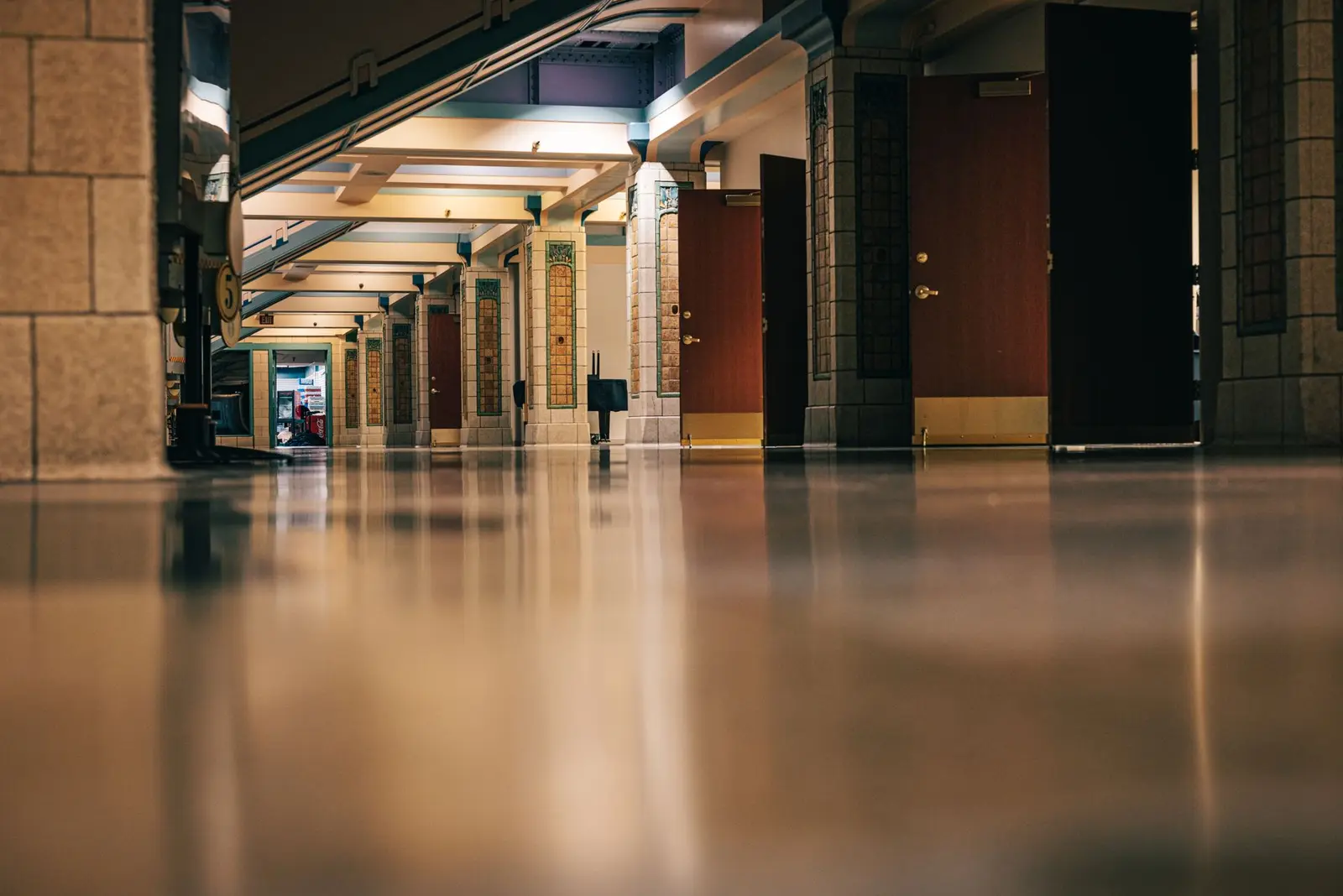A polished corridor floor reflecting the ceiling lights
